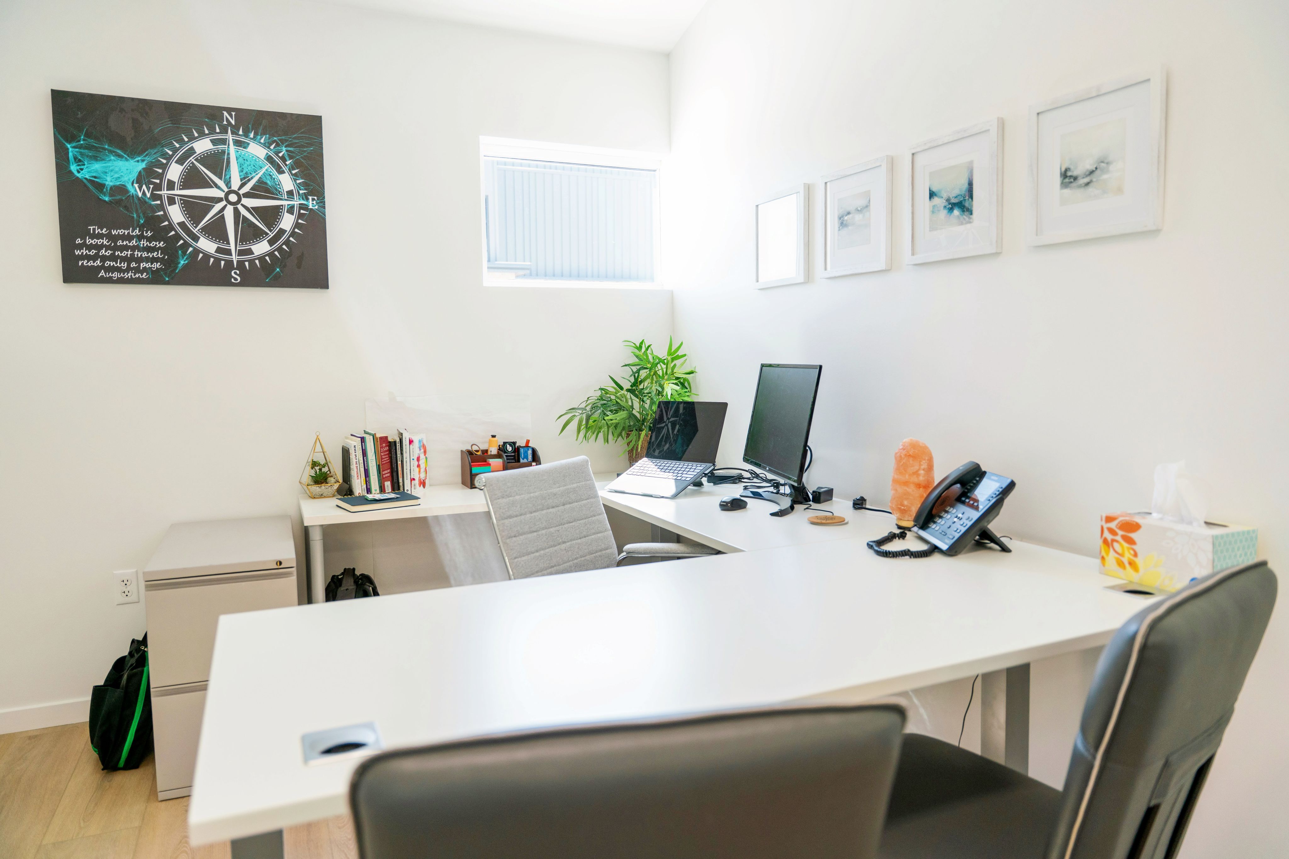 Modern office space with a desk, computer and decor.